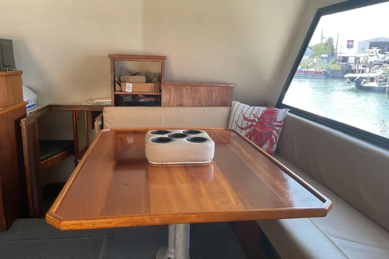 Slide: The Image of Interior of a 1989 Torres 43 boat with wooden table and seating area. - 13