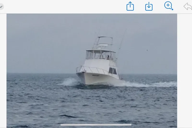 Slide: The Image of 1989 Torres 43 boat cruising on open sea under cloudy sky. - 2