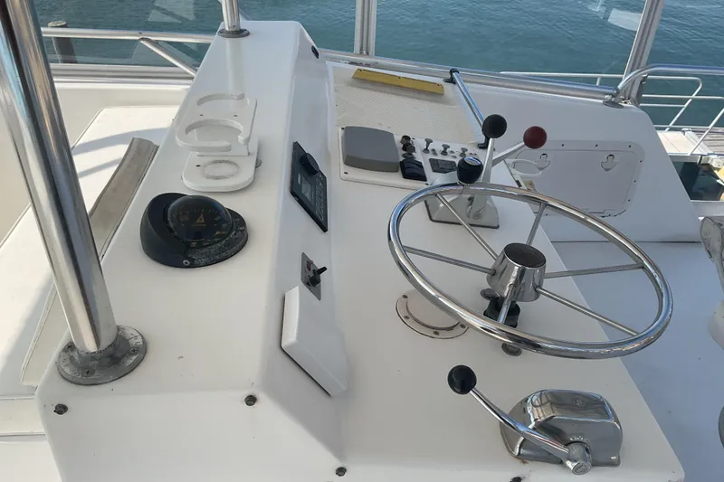 Slide: The Image of Helm of 1989 Torres 43 boat with steering wheel and navigation controls. - 5