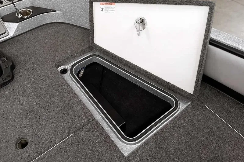 Slide: The Image of 2020 Ranger 1880MS Angler boat storage compartment with open lid, showcasing interior space. - 20