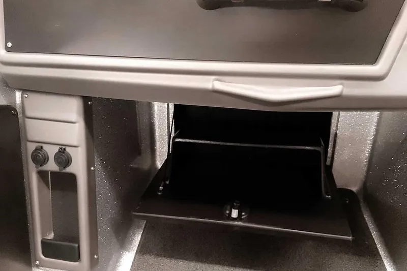 Slide: The Image of 2020 Ranger 1880MS Angler boat dashboard with storage compartment and control panel. - 31