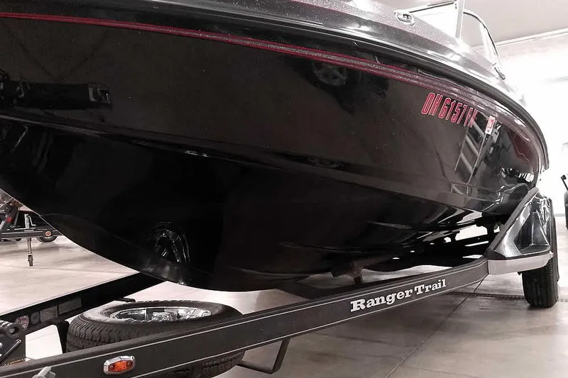 Slide: The Image of 2020 Ranger 1880MS Angler boat on trailer, black hull, indoor setting. - 6
