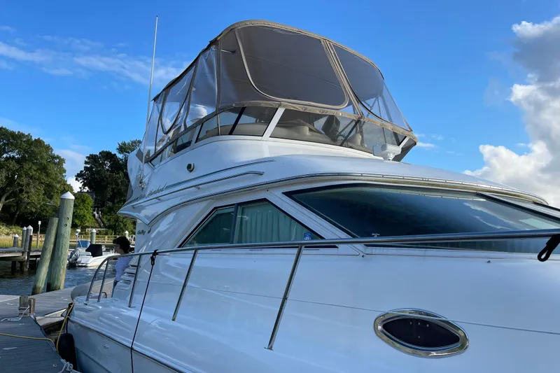 The Image of 2000 Sea Ray 400 Sedan Bridge yacht docked under clear blue sky. - 0