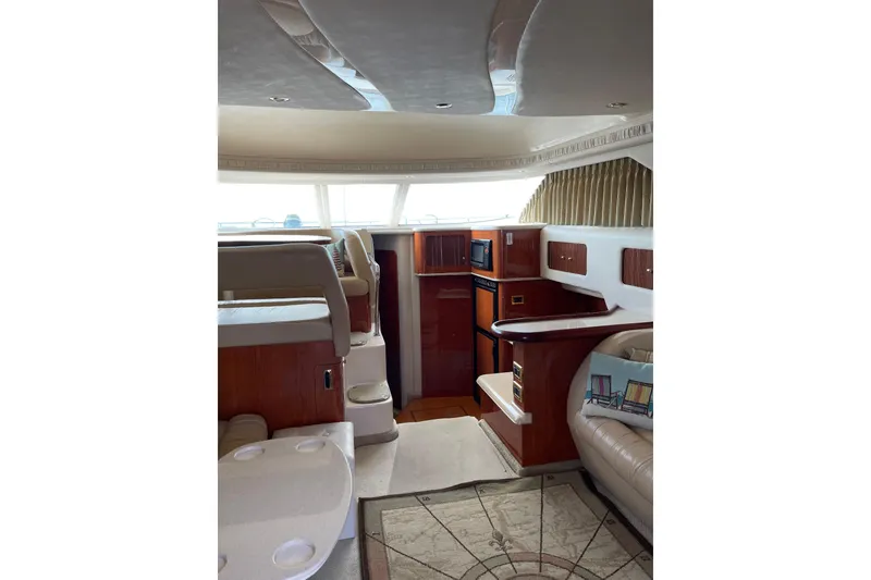 Slide: The Image of Luxurious interior of 2000 Sea Ray 400 Sedan Bridge yacht with elegant wood finishes. - 16