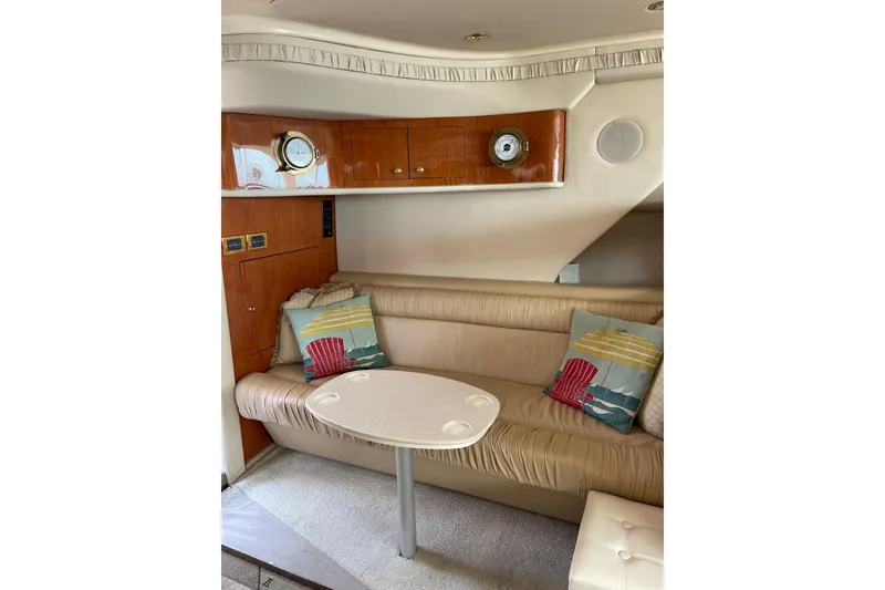 Slide: The Image of Interior of 2000 Sea Ray 400 Sedan Bridge with beige seating and nautical decor. - 17