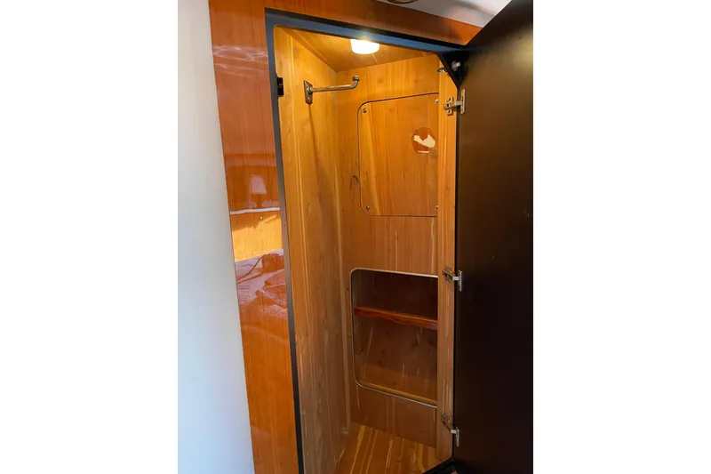 Slide: The Image of Wooden interior closet on 2000 Sea Ray 400 Sedan Bridge yacht. - 28