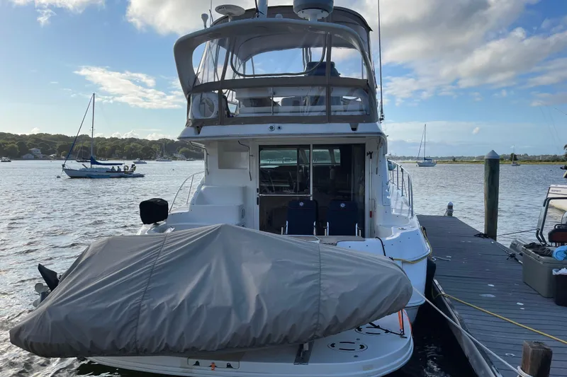 Slide: The Image of 2000 Sea Ray 400 Sedan Bridge yacht docked at marina, covered boat on deck. - 3