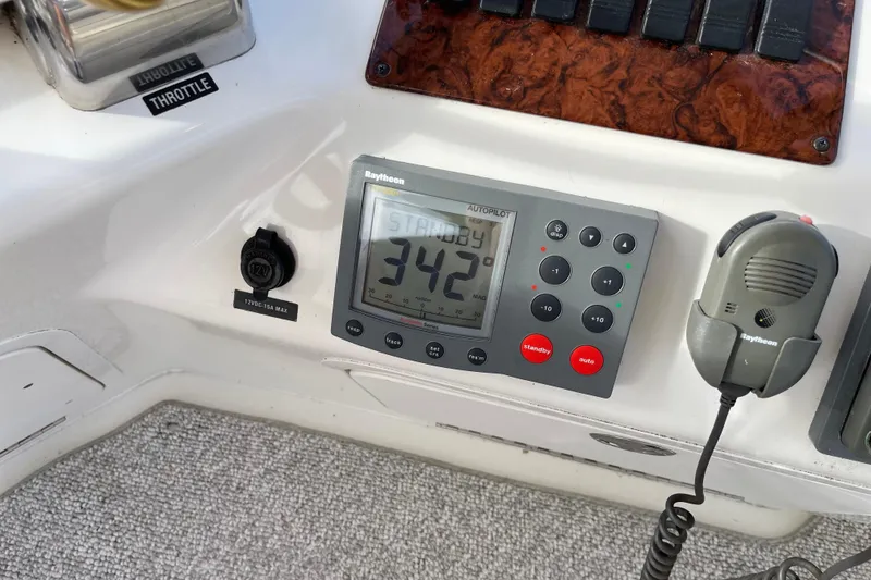 Slide: The Image of Control panel of a 2000 Sea Ray 400 Sedan Bridge with Raytheon autopilot system. - 8