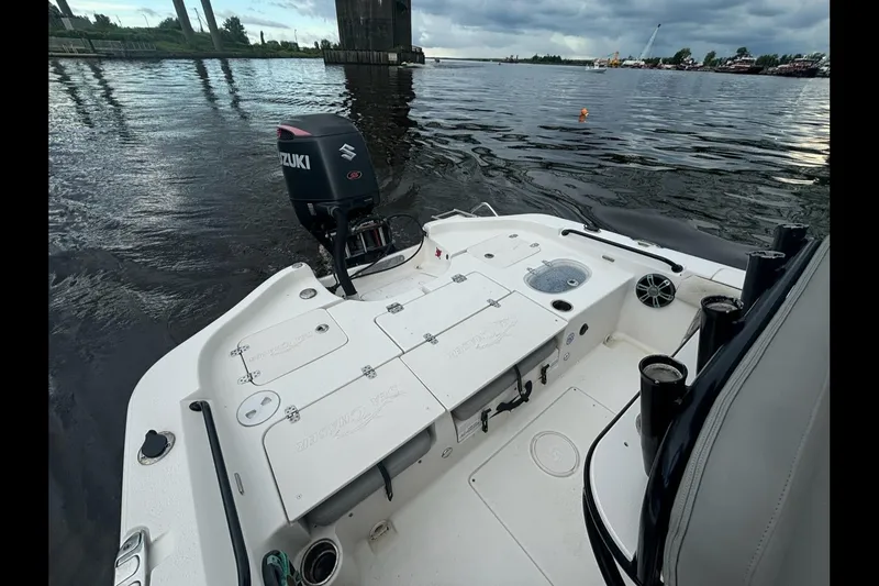 Slide: The Image of 2020 Sea Chaser 23 LX boat with Suzuki outboard motor on a calm river. - 10