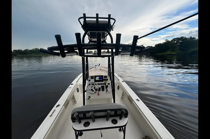 Slide: The Image of 2020 Sea Chaser 23 LX boat on calm water, featuring a central console and rod holders. - 11