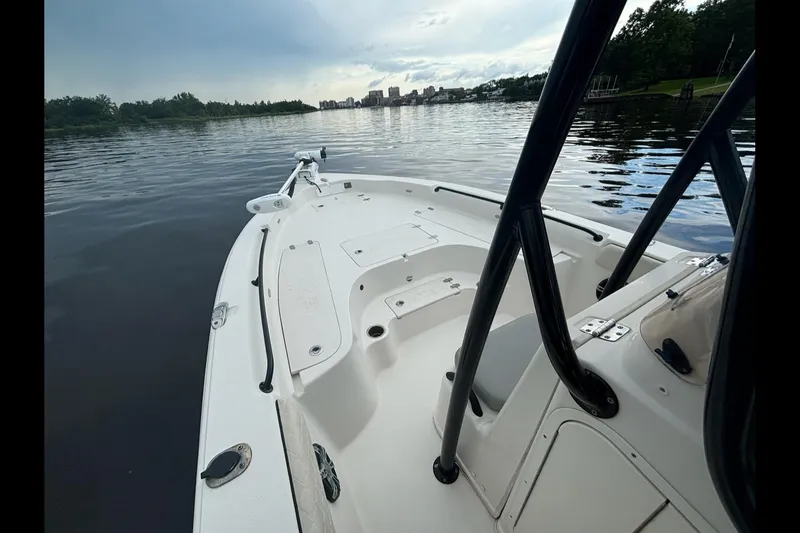 Slide: The Image of 2020 Sea Chaser 23 LX boat on calm water, showcasing spacious deck and sleek design. - 13