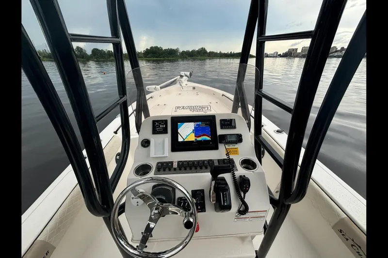 Slide: The Image of 2020 Sea Chaser 23 LX boat dashboard with navigation equipment on calm water. - 14