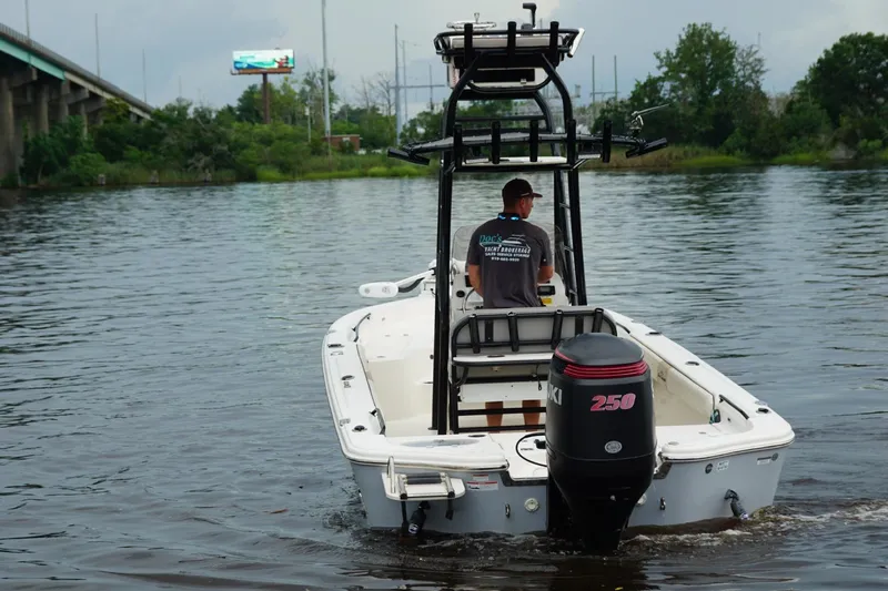 Slide: The Image of 2020 Sea Chaser 23 LX boat on water, with Suzuki 250 engine, near bridge. - 3