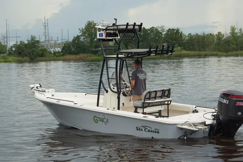 Slide: The Image of 2020 Sea Chaser 23 LX boat on calm water with Suzuki outboard motor. - 4