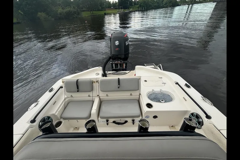 Slide: The Image of 2020 Sea Chaser 23 LX boat interior with seating and Suzuki outboard motor on water. - 6