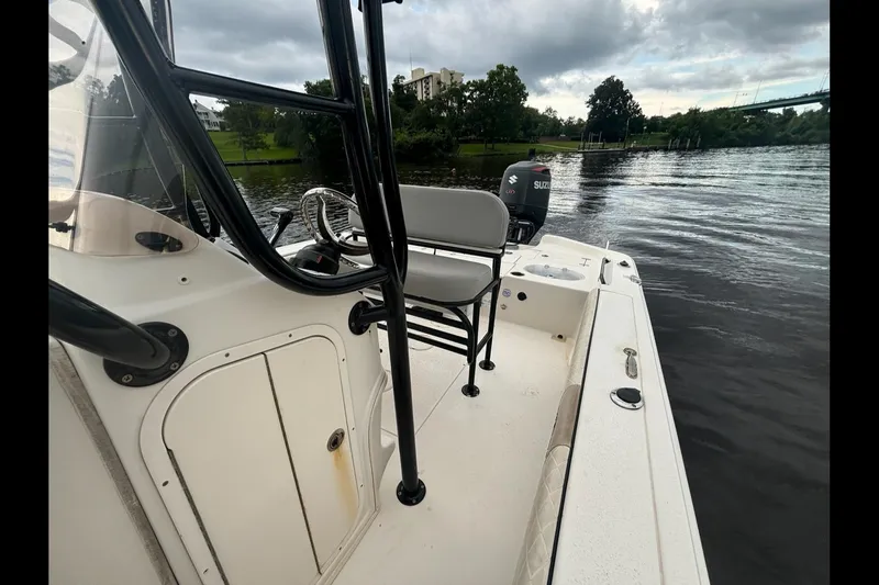 Slide: The Image of 2020 Sea Chaser 23 LX boat on calm water, featuring a Suzuki outboard motor. - 7