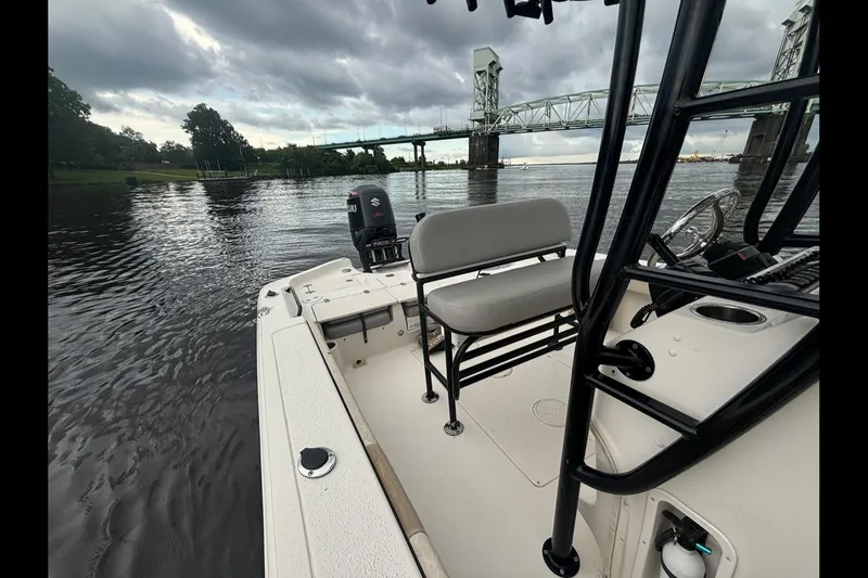 Slide: The Image of 2020 Sea Chaser 23 LX boat on a river near a bridge under cloudy skies. - 8