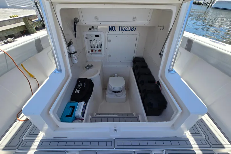 Slide: The Image of 2004 SeaVee 340B boat interior with toilet, storage, and control panel. - 13