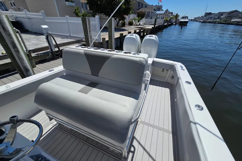 Slide: The Image of 2004 SeaVee 340B boat docked, featuring dual engines and spacious seating. - 15