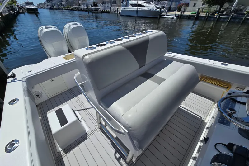 Slide: The Image of 2004 SeaVee 340B boat interior with dual engines, docked in a marina. - 16