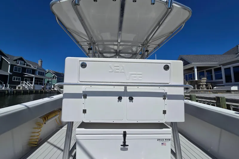 Slide: The Image of 2004 SeaVee 340B boat docked, featuring a center console and T-top under clear blue skies. - 17