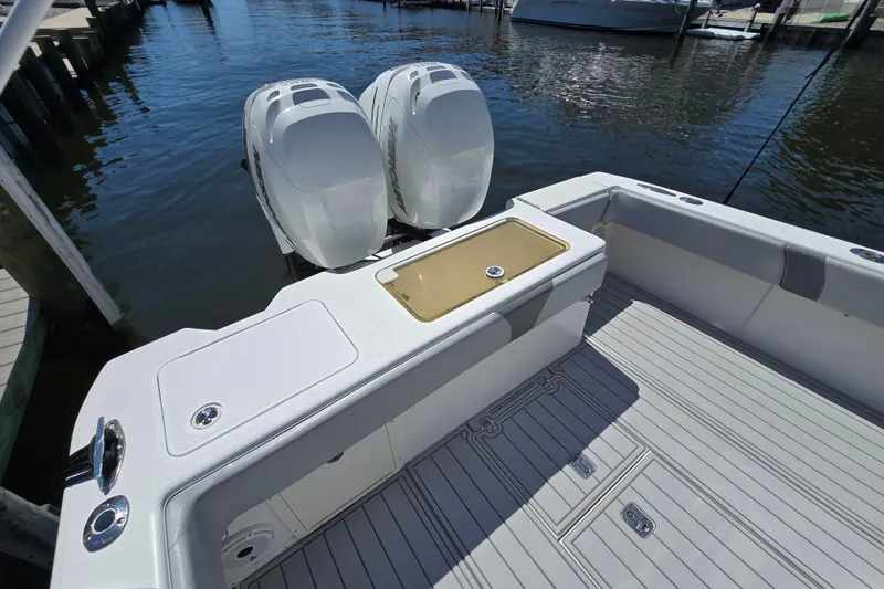 Slide: The Image of 2004 SeaVee 340B boat with twin outboard engines, docked on calm water. - 18