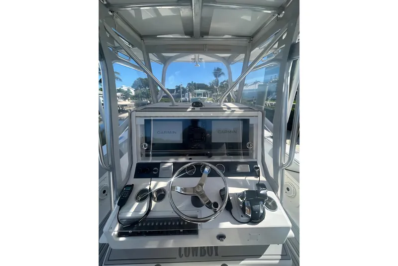Slide: The Image of 2004 SeaVee 340B boat helm with Garmin navigation system and steering wheel. - 23