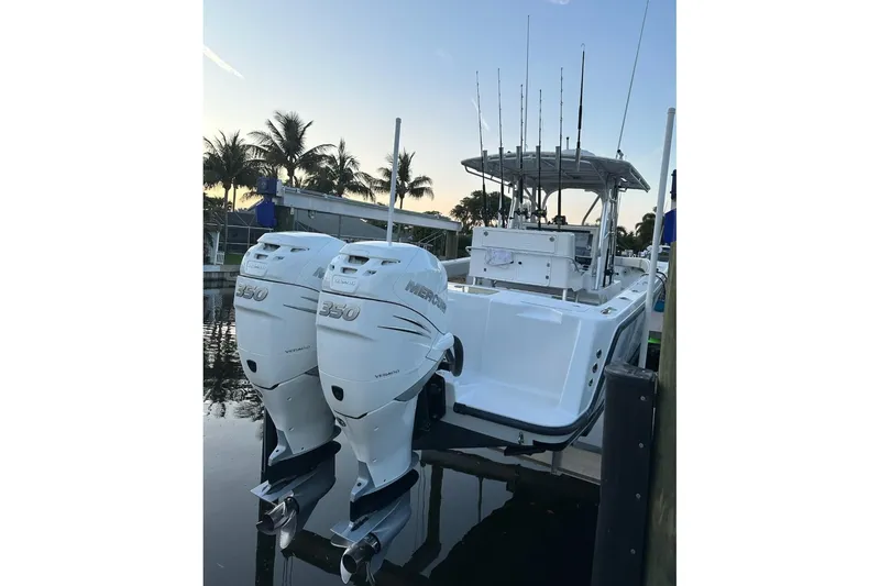 Slide: The Image of 2004 SeaVee 340B boat with twin Mercury 350 engines docked at sunset. - 3