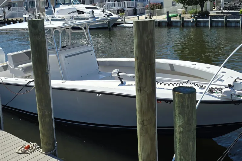 Slide: The Image of 2004 SeaVee 340B boat docked at a marina, featuring a sleek white design. - 8