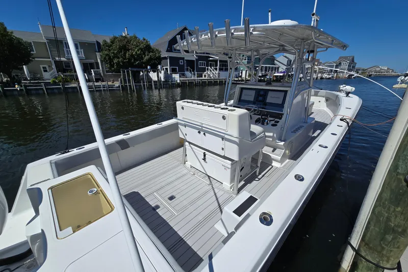 Slide: The Image of 2004 SeaVee 340B boat docked, featuring spacious deck and modern navigation equipment. - 9