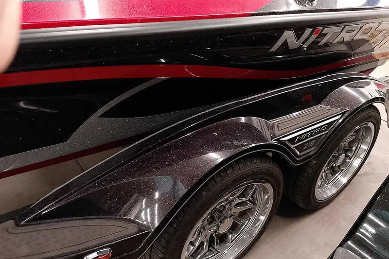 Slide: The Image of 2022 Nitro Z19 SC boat trailer with sleek design and chrome wheels. - 12