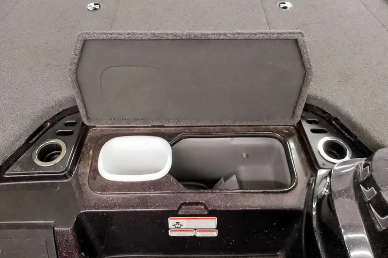 Slide: The Image of 2022 Nitro Z19 SC boat storage compartment with open lid and cup holders. - 19