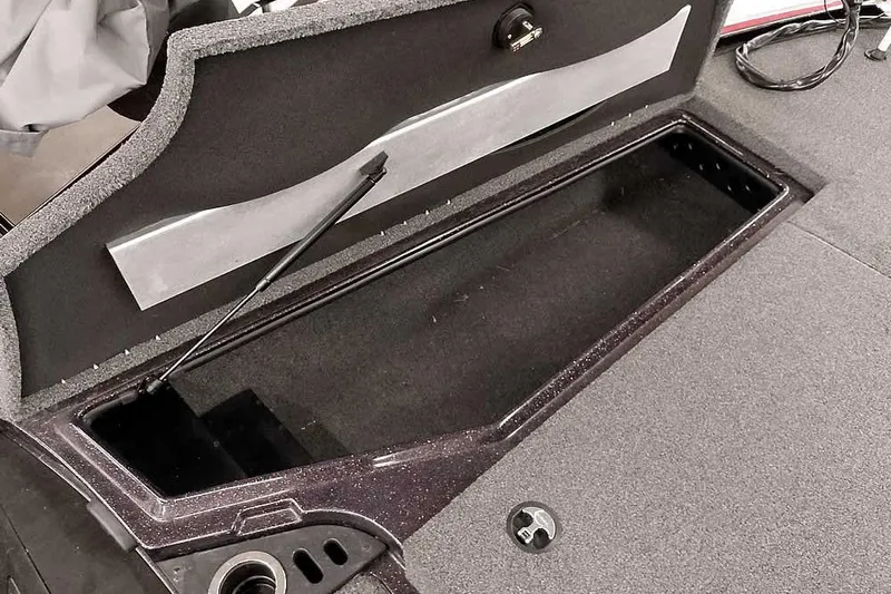 Slide: The Image of 2022 Nitro Z19 SC boat storage compartment with open lid and carpeted interior. - 22