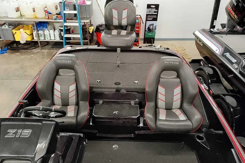 Slide: The Image of 2022 Nitro Z19 SC boat interior with three seats and steering wheel in a garage setting. - 25