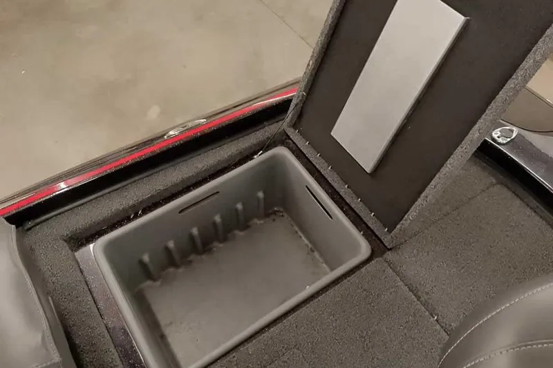 Slide: The Image of Open storage compartment in 2022 Nitro Z19 SC boat, featuring carpeted interior. - 36