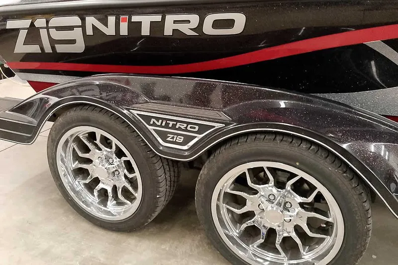 Slide: The Image of 2022 Nitro Z19 SC boat trailer with chrome wheels and bold branding. - 40