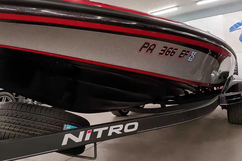 Slide: The Image of 2022 Nitro Z19 SC boat on trailer, close-up view of hull and registration. - 7