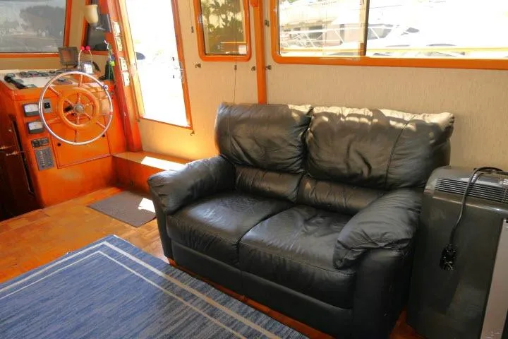 Slide: The Image of Interior of 1983 CHB 45 boat with leather sofa and steering wheel. - 11