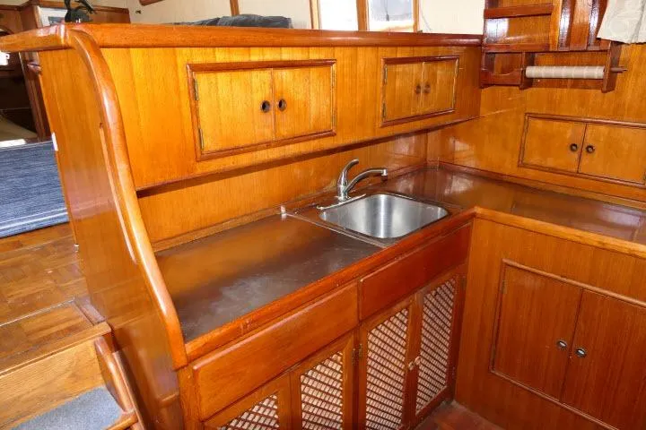 Slide: The Image of Wooden interior of 1983 CHB 45 boat with sink and cabinets. - 14