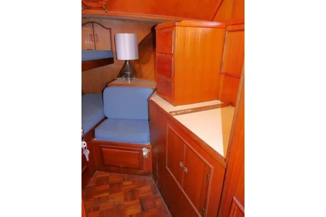 Slide: The Image of Interior of 1983 CHB 45 boat with wooden cabinetry and blue cushions. - 20