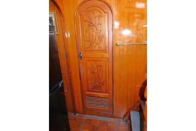 Slide: The Image of Wooden interior door with carved floral design on 1983 CHB 45 boat. - 26