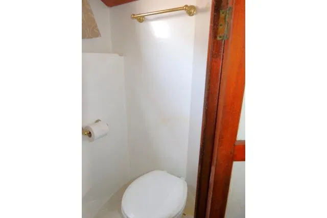 Slide: The Image of Toilet area in 1983 CHB 45 boat with wooden door and brass fixtures. - 28
