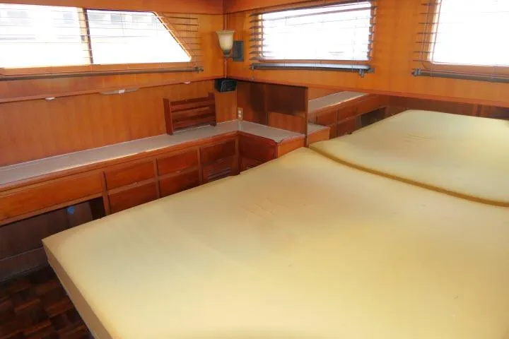 Slide: The Image of Interior of 1983 CHB 45 yacht with wooden furnishings and large bed. - 30
