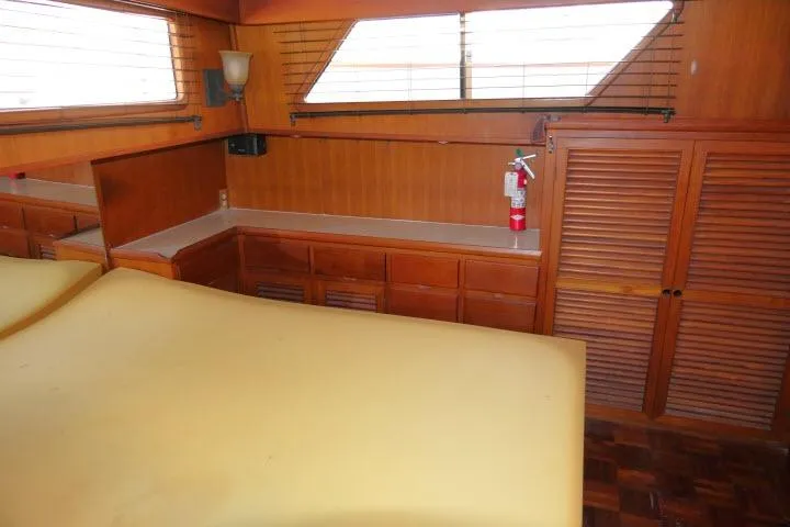 Slide: The Image of Interior of 1983 CHB 45 yacht with wood paneling and storage cabinets. - 32