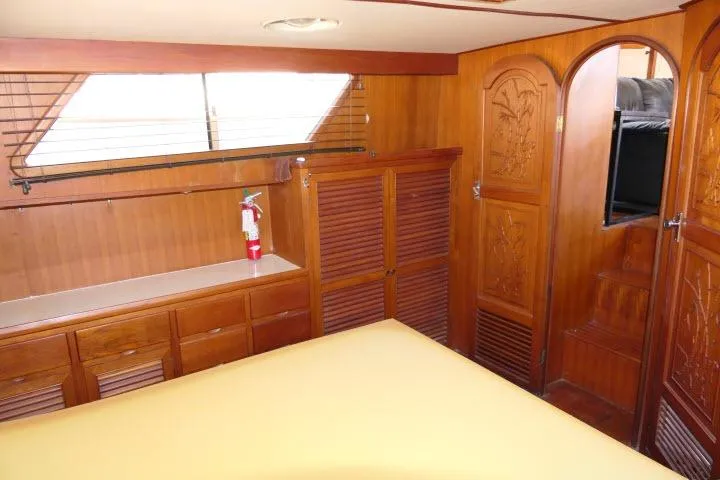 Slide: The Image of 1983 CHB 45 yacht interior with wooden cabinetry and carved doors. - 33