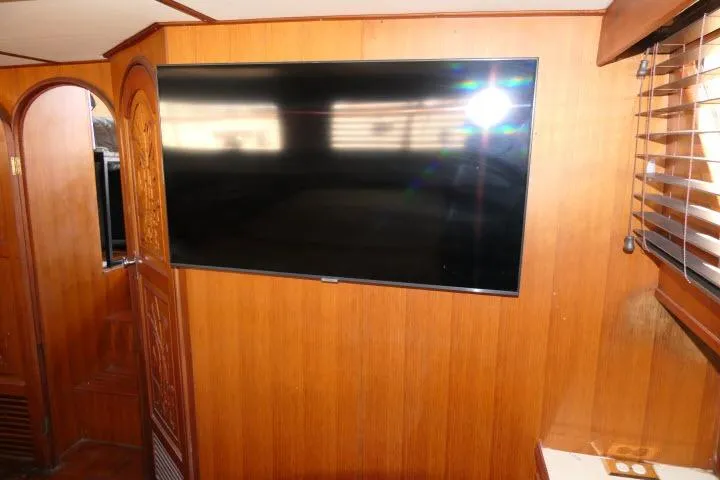 Slide: The Image of Interior of 1983 CHB 45 boat with mounted flat-screen TV on wooden wall. - 34
