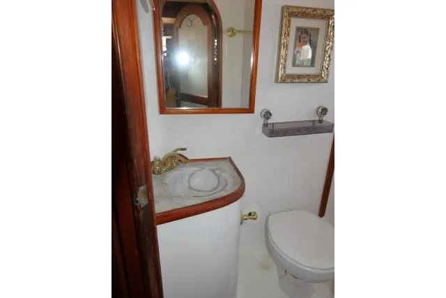 Slide: The Image of Bathroom interior of 1983 CHB 45 boat with sink, toilet, and framed artwork. - 35