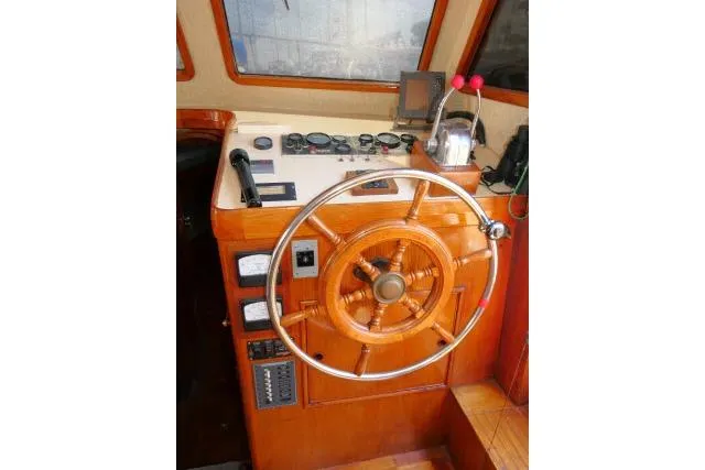 Slide: The Image of Helm of 1983 CHB 45 boat with wooden wheel and control panel. - 37