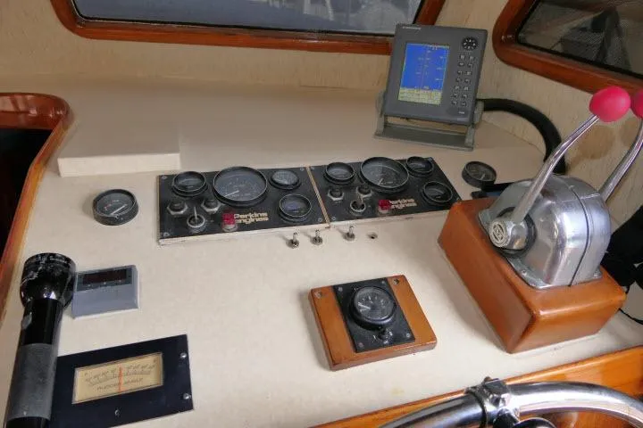 Slide: The Image of Control panel of a 1983 CHB 45 boat with gauges and navigation equipment. - 38