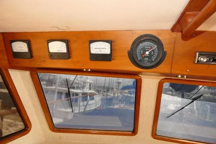 Slide: The Image of Interior view of a 1983 CHB 45 boat dashboard with gauges and windows. - 39